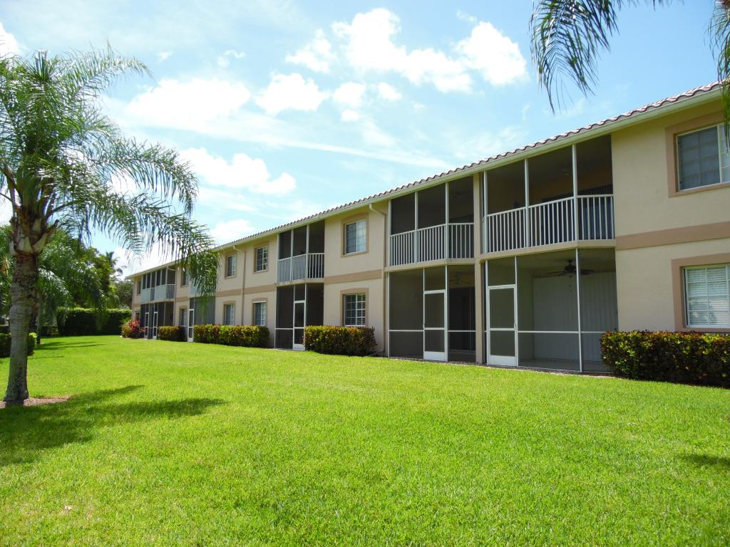 9009 Michael Circle, Unit 109 Naples, FL 34113 - Photo 14 of 18 a view of a house with a yard