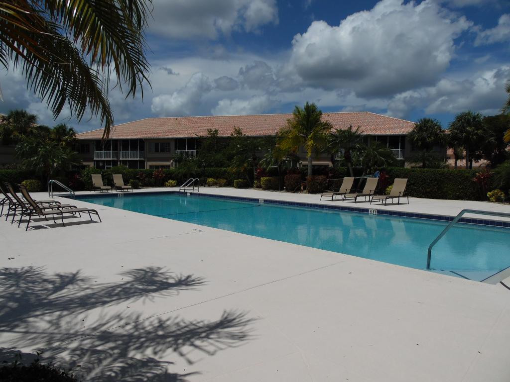9009 Michael Circle, Unit 109 Naples, FL 34113 - Photo 18 of 18 a view of a swimming pool with a yard