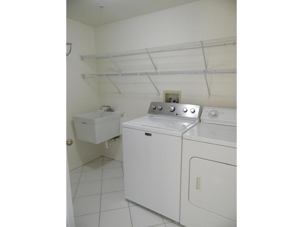 9009 Michael Circle, Unit 109 Naples, FL 34113 - Photo 9 of 18 a utility room with dryer and washer
