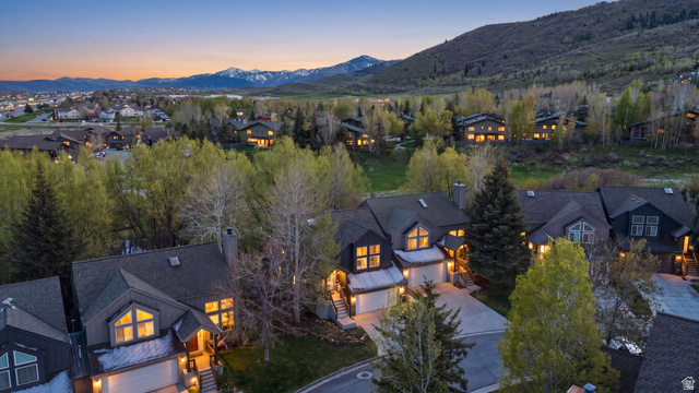 7935 Mustang Loop Road Park City, UT 84098 - Photo 56 of 60 Modern mountain-style residence featuring dark siding, multiple gables, a two-car garage, and a concrete driveway