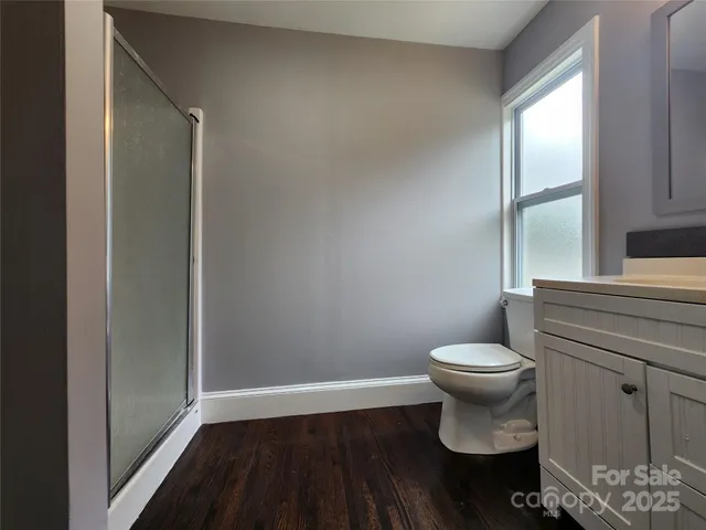 a bathroom with a toilet and a window