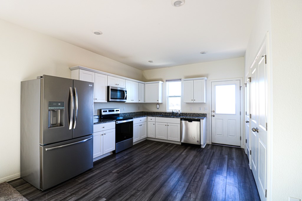 627 Alterra Way Maxwell, TX 78656 - Photo 2 of 10 a kitchen with a refrigerator a stove top oven and wooden floor