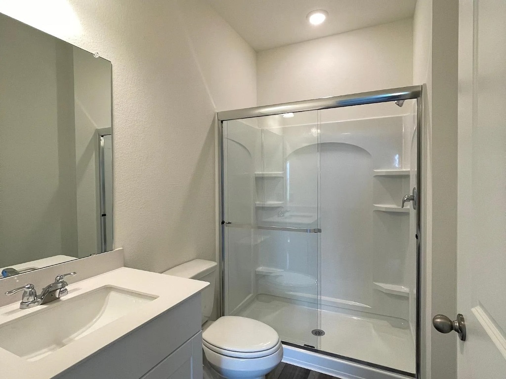 627 Alterra Way Maxwell, TX 78656 - Photo 5 of 10 a bathroom with a shower sink vanity mirror and toilet