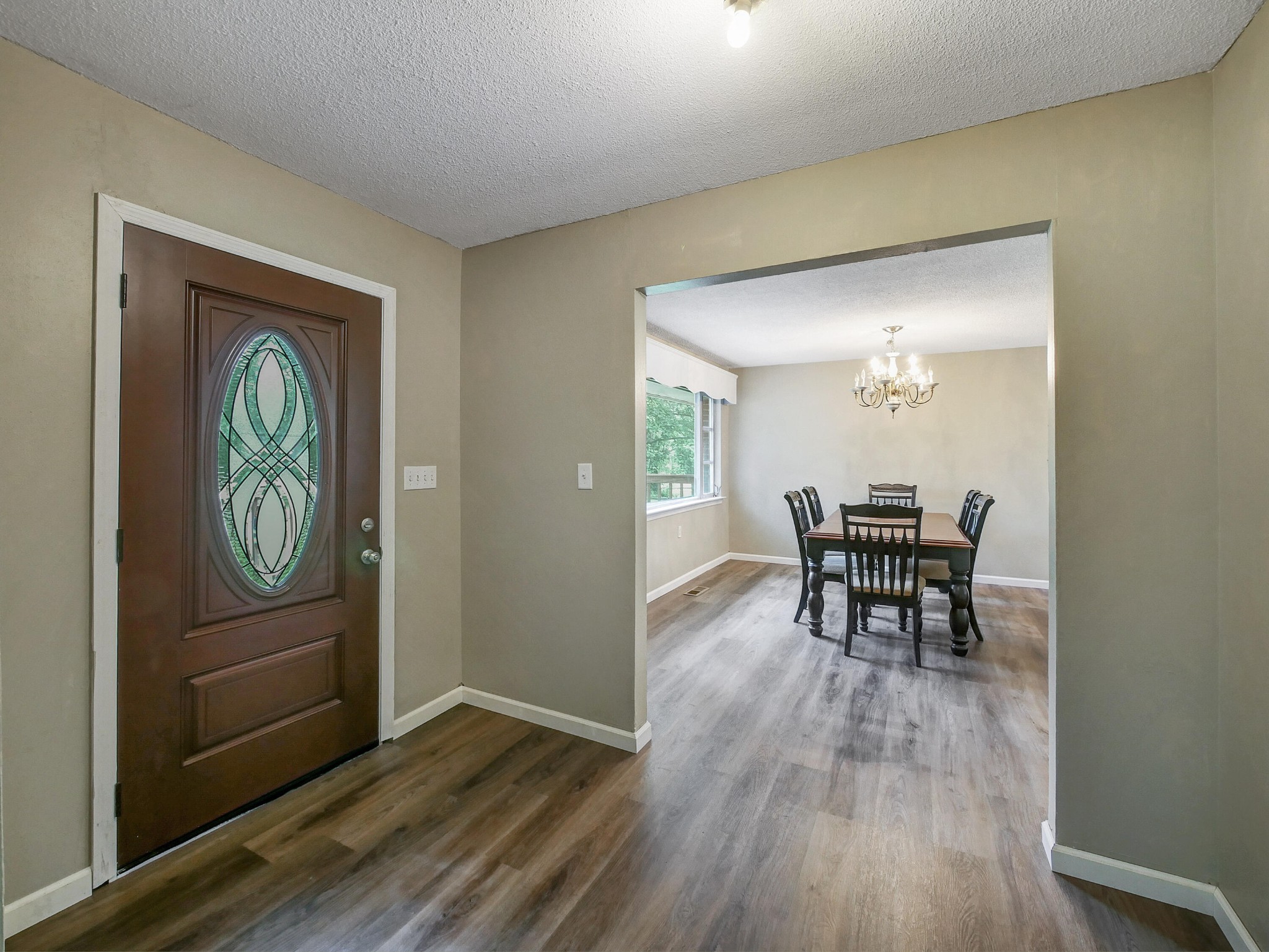 902 Lindsay Avenue Chattanooga, TN 37421 - Photo 4 of 29 a view of a hallway with wooden floor a fireplace and dining room