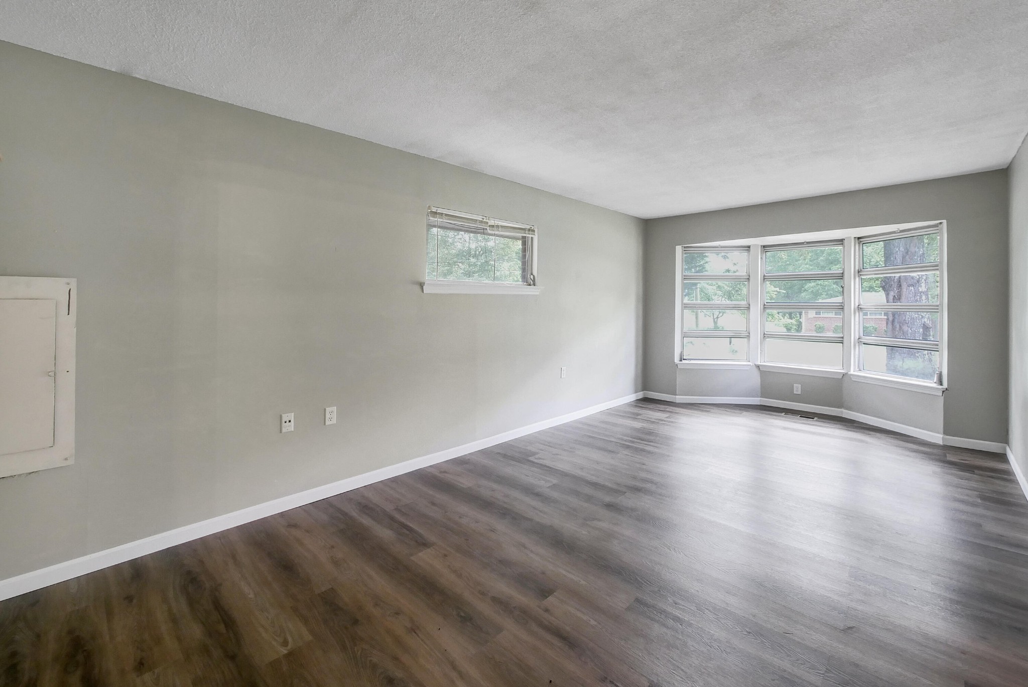 902 Lindsay Avenue Chattanooga, TN 37421 - Photo 7 of 29 an empty room with wooden floor and windows