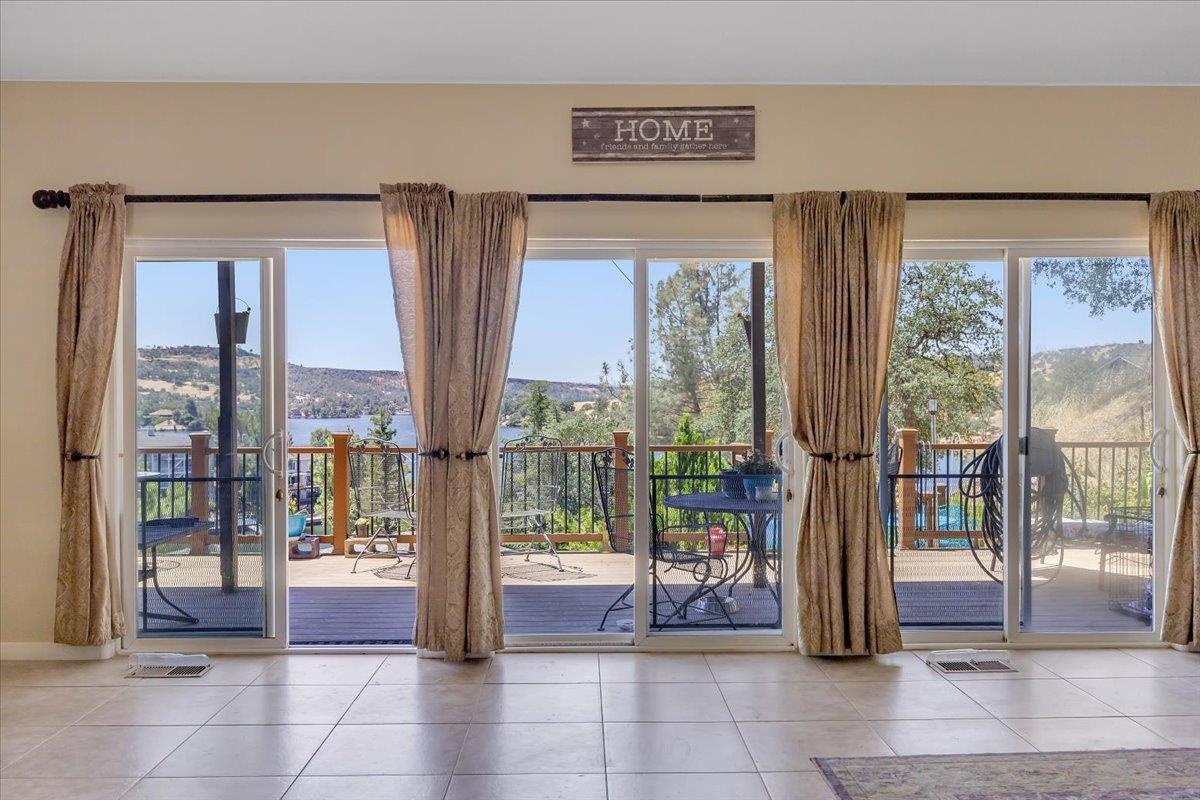 411 Sunrise Road Copperopolis, CA 95228 - Photo 10 of 76 A wall of sliders for lake breezes and VIEWS!