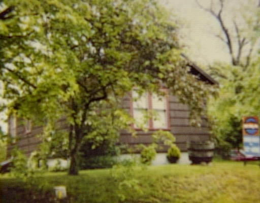 a view of house with yard