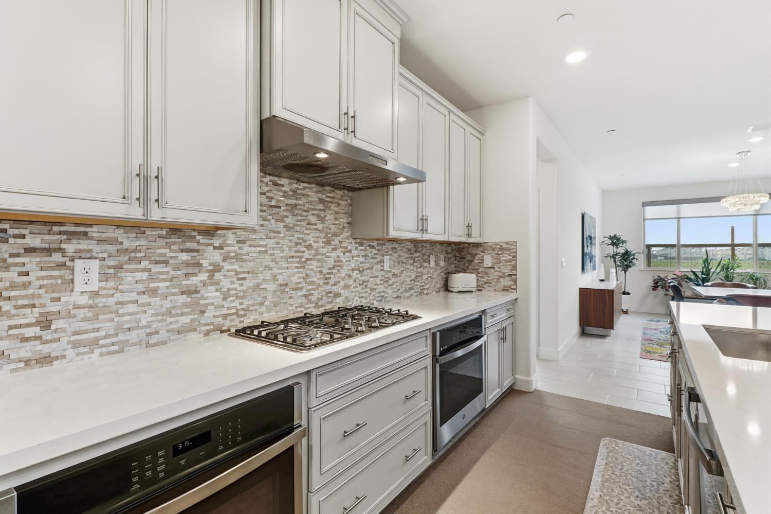 5321 Fandango Loop Roseville, CA 95747 - Photo 12 of 38 a kitchen with stainless steel appliances a stove a sink and cabinets