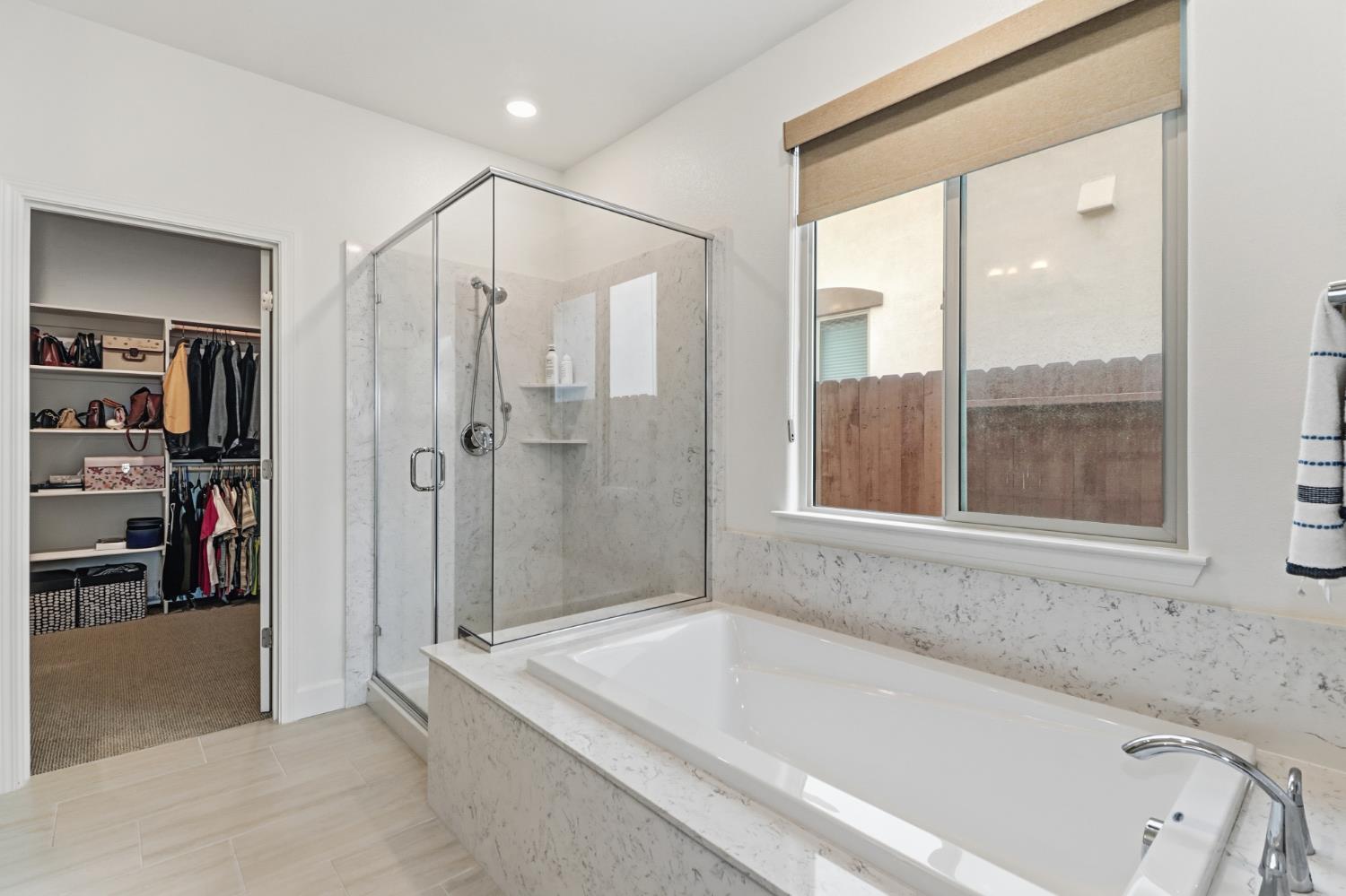 5321 Fandango Loop Roseville, CA 95747 - Photo 23 of 38 a bathroom with a bathtub and a shower