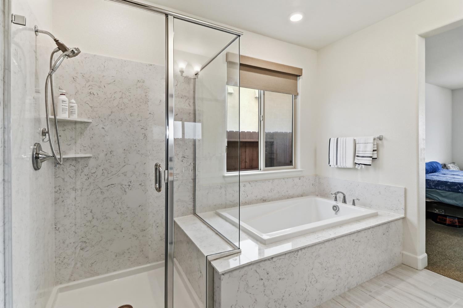 5321 Fandango Loop Roseville, CA 95747 - Photo 24 of 38 a bathroom with a tub sink and shower