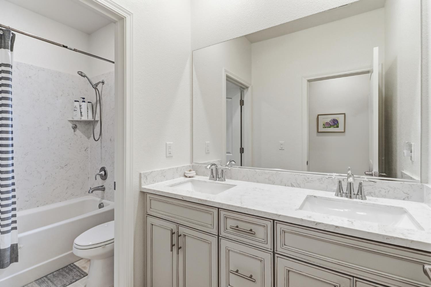 5321 Fandango Loop Roseville, CA 95747 - Photo 26 of 38 a bathroom with a granite countertop sink a toilet and a bathtub
