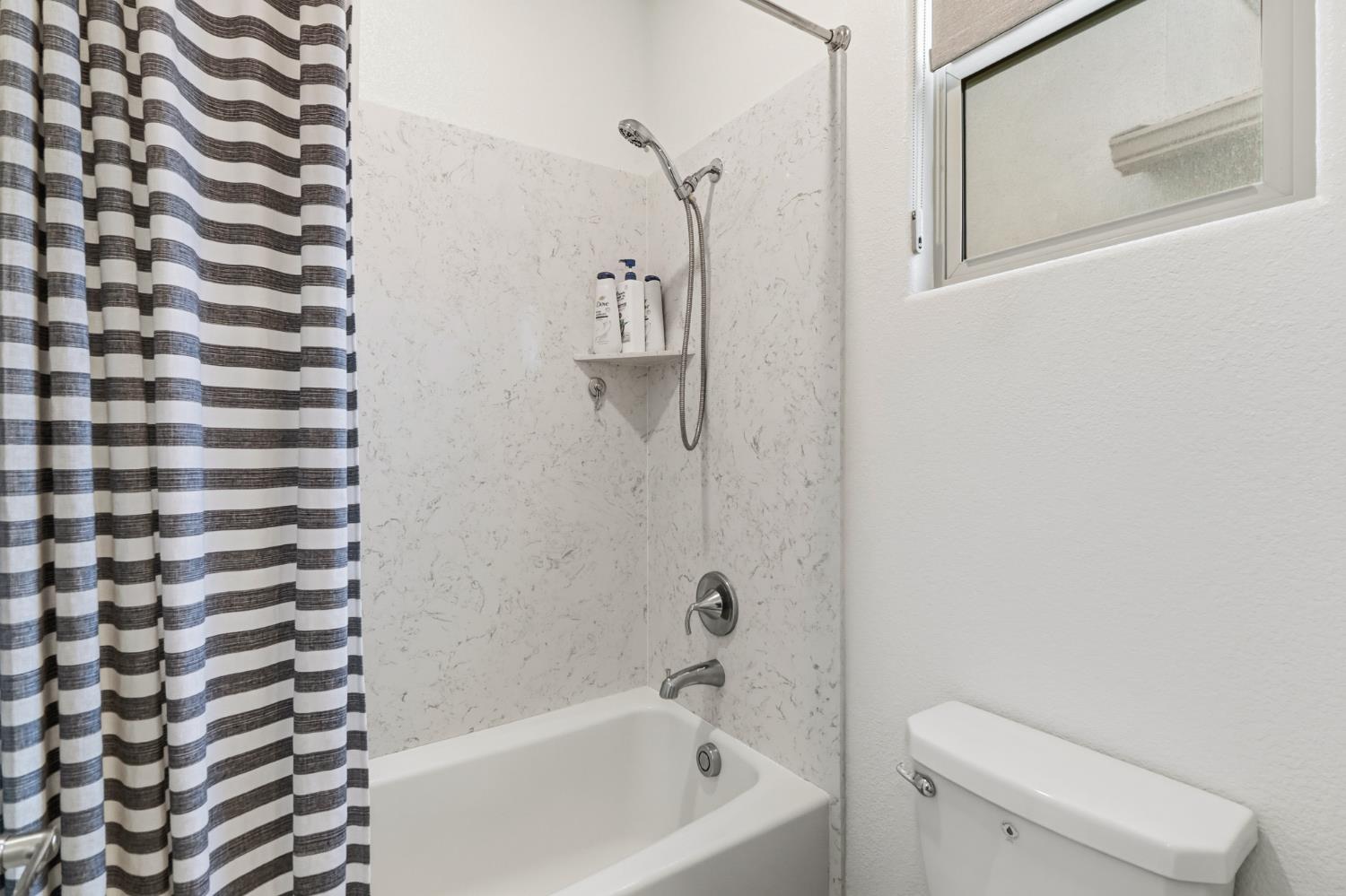 5321 Fandango Loop Roseville, CA 95747 - Photo 27 of 38 a bathroom with a bathtub and a shower