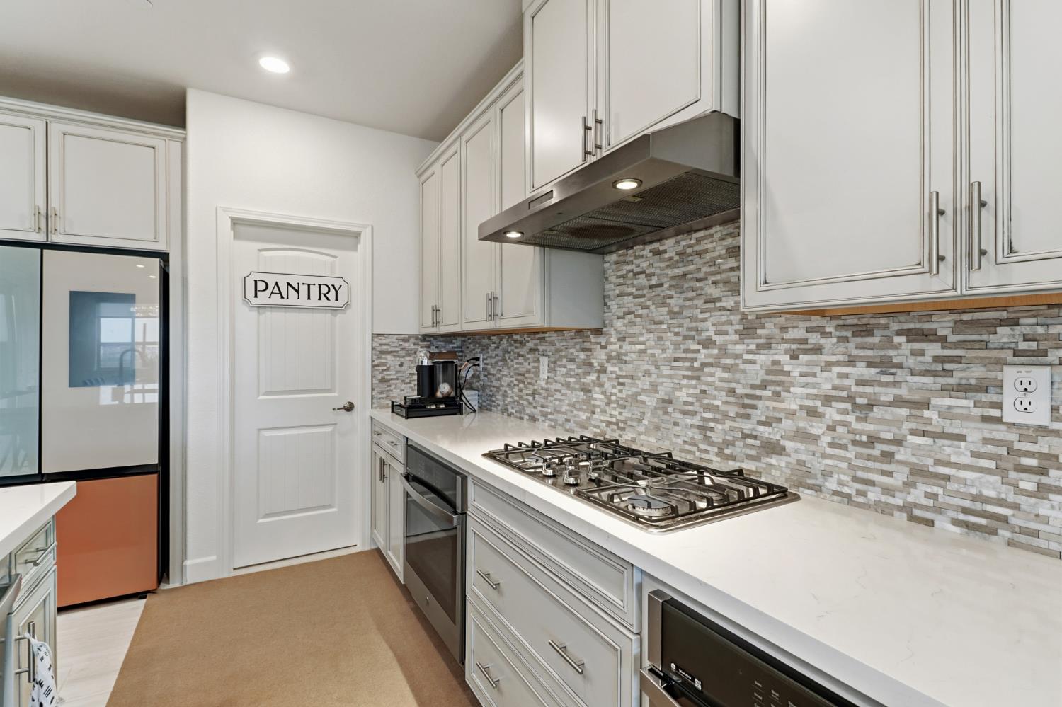 5321 Fandango Loop Roseville, CA 95747 - Photo 10 of 38 a kitchen with stainless steel appliances a stove a refrigerator and cabinets