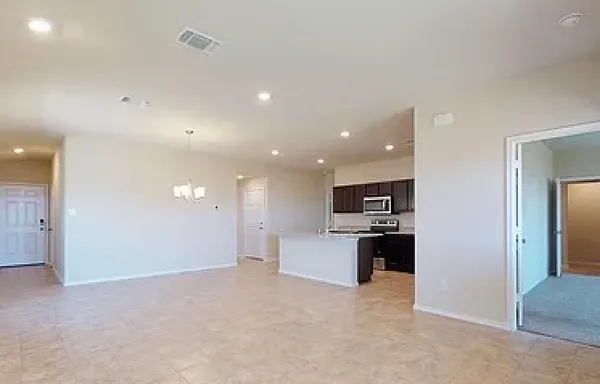 a view of kitchen with stainless steel appliances granite countertop refrigerator and stove