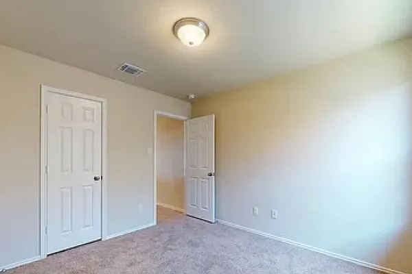 an empty room with an entryway door