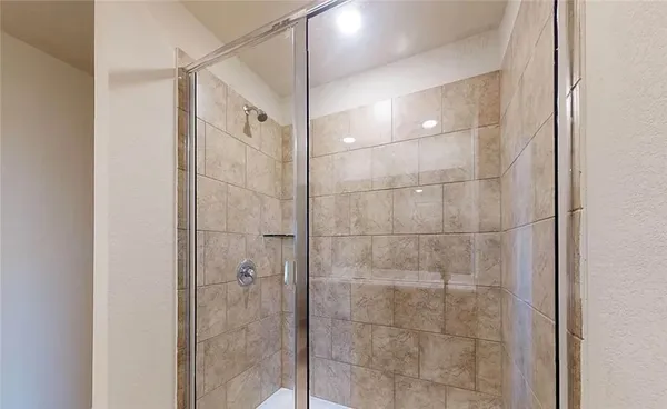 a bathroom with a glass shower door