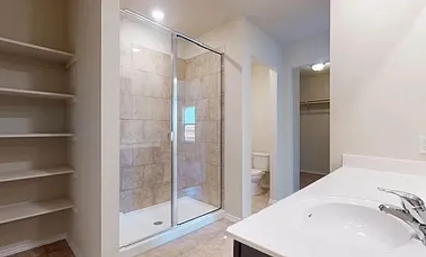 a bathroom with a shower and a sink
