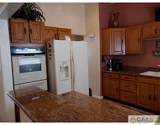 43 Poplar Road Piscataway, NJ 08854 - Photo 12 of 21 a kitchen with stainless steel appliances granite countertop a refrigerator a stove and a sink
