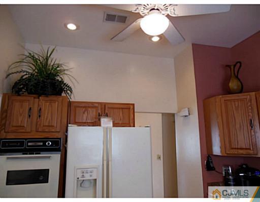 43 Poplar Road Piscataway, NJ 08854 - Photo 13 of 21 a kitchen with stainless steel appliances a stove a microwave a sink and cabinets