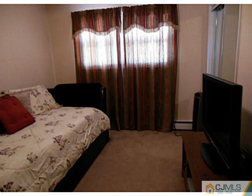 43 Poplar Road Piscataway, NJ 08854 - Photo 18 of 21 a bedroom with a bed and a dresser