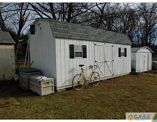 43 Poplar Road Piscataway, NJ 08854 - Photo 8 of 21 a backyard of a house with table and chairs