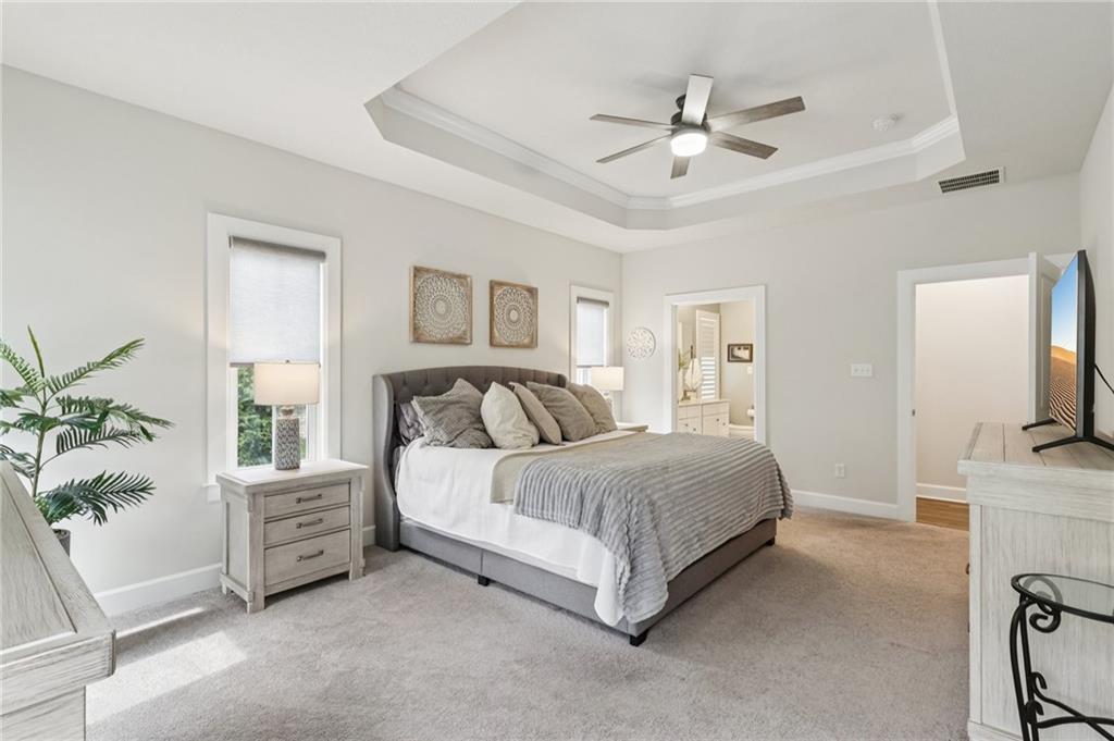 320 Crest Lane Mars, PA 16046 - Photo 17 of 37 a spacious bedroom with a bed a couch and a potted plant