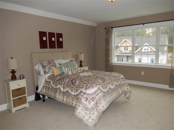 42 Rowley Country Club Road, Unit 42 Boxford, MA 01921 - Photo 5 of 7 a bed sitting in a bedroom next to a window