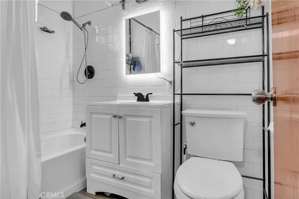 a kitchen with stainless steel appliances granite countertop a refrigerator sink and stove