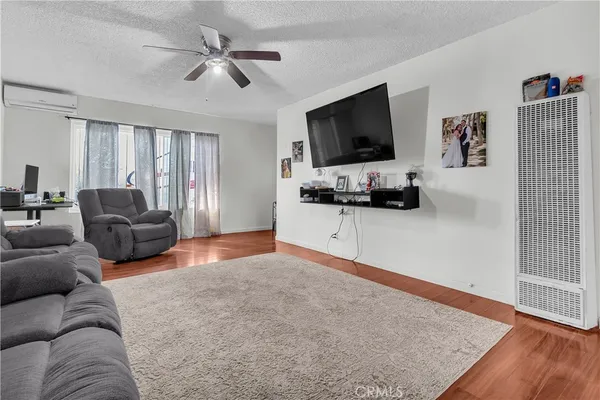 a kitchen with stainless steel appliances granite countertop a table chairs sink and cabinets
