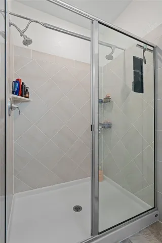 a bathroom with a shower and a shower