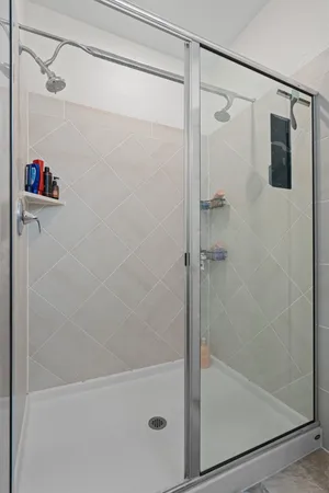 a bathroom with a shower and a shower