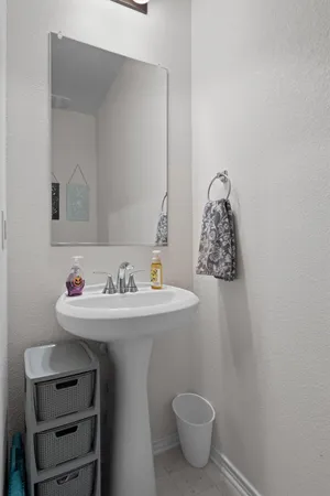 a bathroom with a sink toilet and a mirror