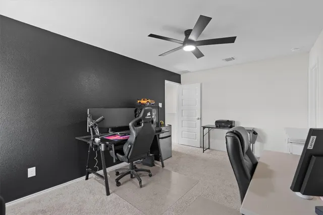 a view of a workspace with furniture and a air conditioner vent