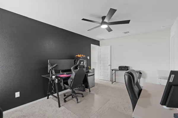 a view of a workspace with furniture and a air conditioner vent