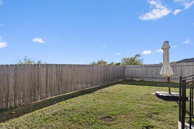 a view of a backyard with table and chairs