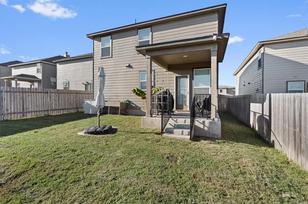 a view of a backyard with table and chairs