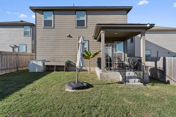 a view of a house with backyard and porch