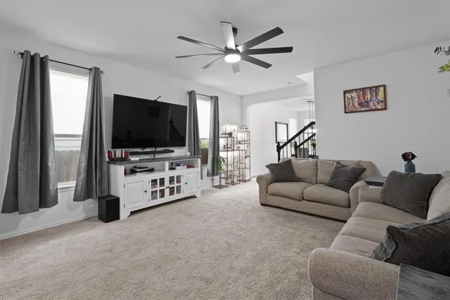 a living room with furniture and a flat screen tv