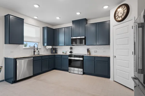 a kitchen with a sink cabinets and stainless steel appliances