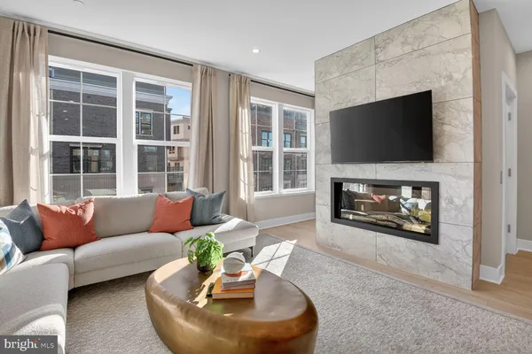 a living room with furniture a fireplace and a flat screen tv