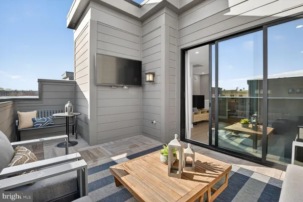 a backyard of a house with barbeque oven table and chairs