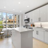 a kitchen with sink cabinets and window
