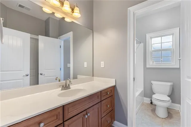 a bathroom with a toilet a sink and a mirror