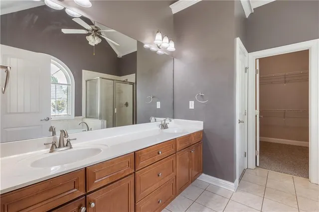a spacious bathroom with a double vanity sink and a mirror