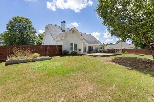 a front view of a house with a yard and trees