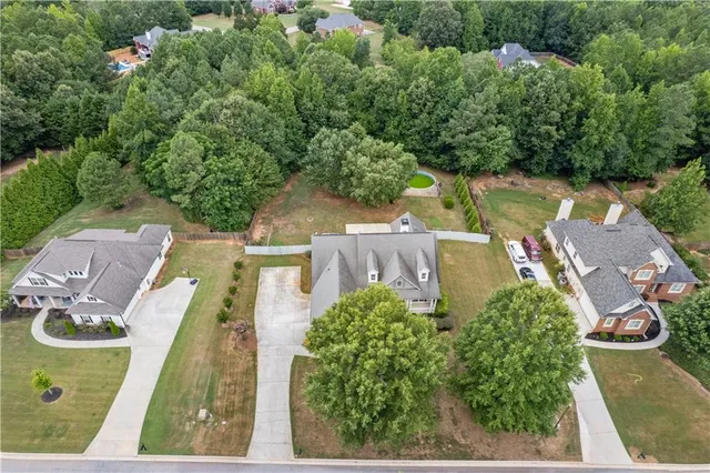 an aerial view of a house with garden space and street view