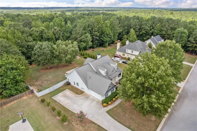 an aerial view of a house with a yard