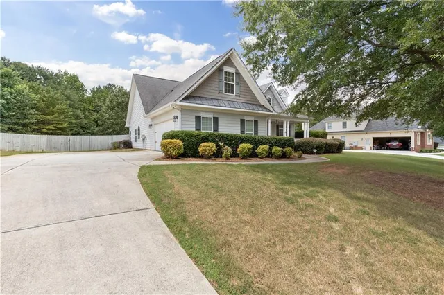 a front view of house with yard and green space