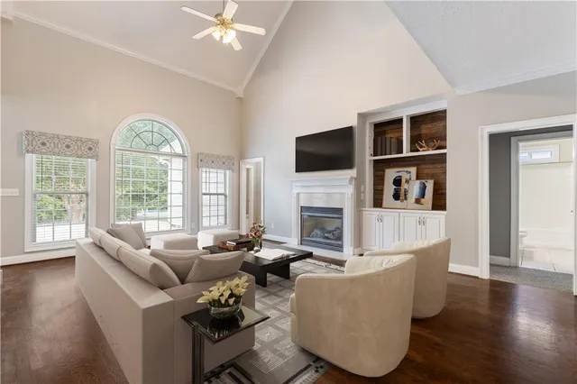 a living room with furniture a fireplace and a flat screen tv