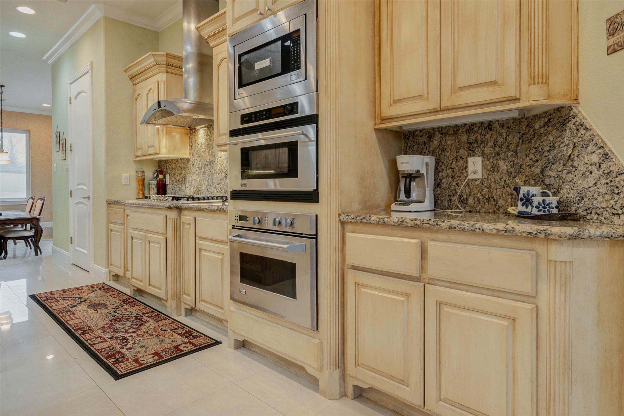 2732 Broadway Street Dickinson, TX 77539 - Photo 10 of 50 a kitchen with stainless steel appliances granite countertop a stove a sink and a microwave